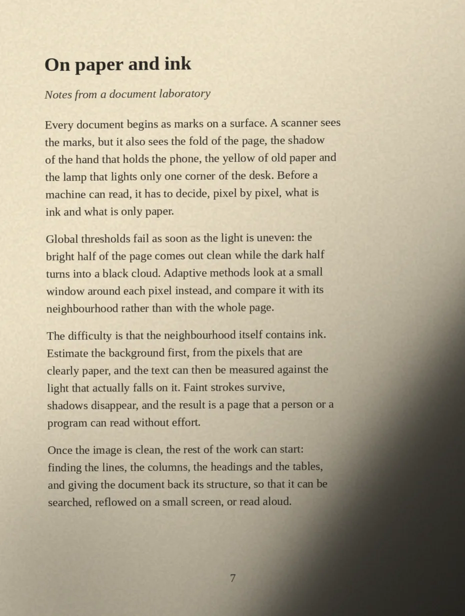 A printed page photographed in poor light: warm cast, dark shadow over the lower right corner.